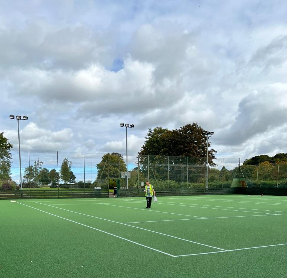 Resurfaced green tennis courts on a sunny day