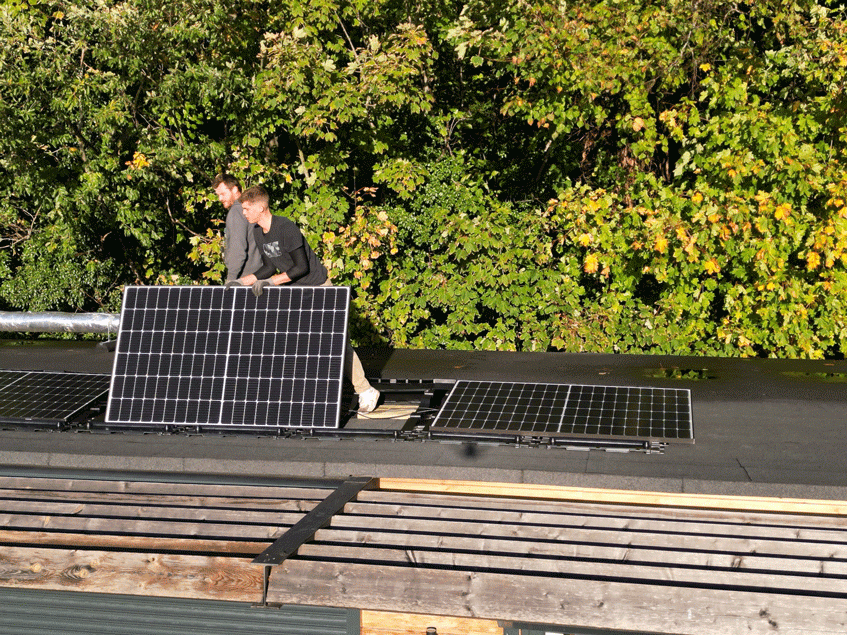 PV panels being installed on the roof of Leatherhead Bowling Club