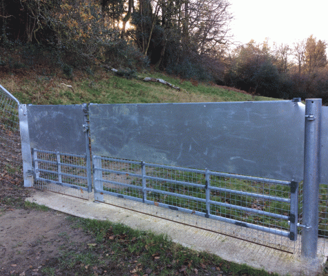 Sturdy gate serves as the entrance to the enclosure for animals and vehicles