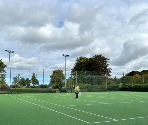 Resurfaced green tennis courts on a sunny day