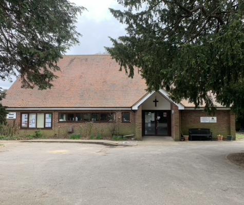 wide shot of the front of the hall bordered by trees