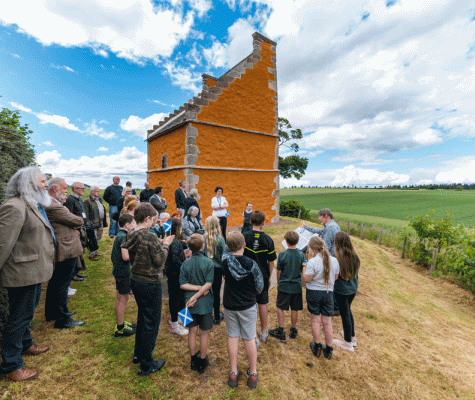 A gathering of people outside the doocot for hte opening ceremony