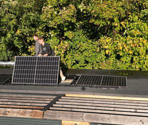 PV panels being installed on the roof of Leatherhead Bowling Club